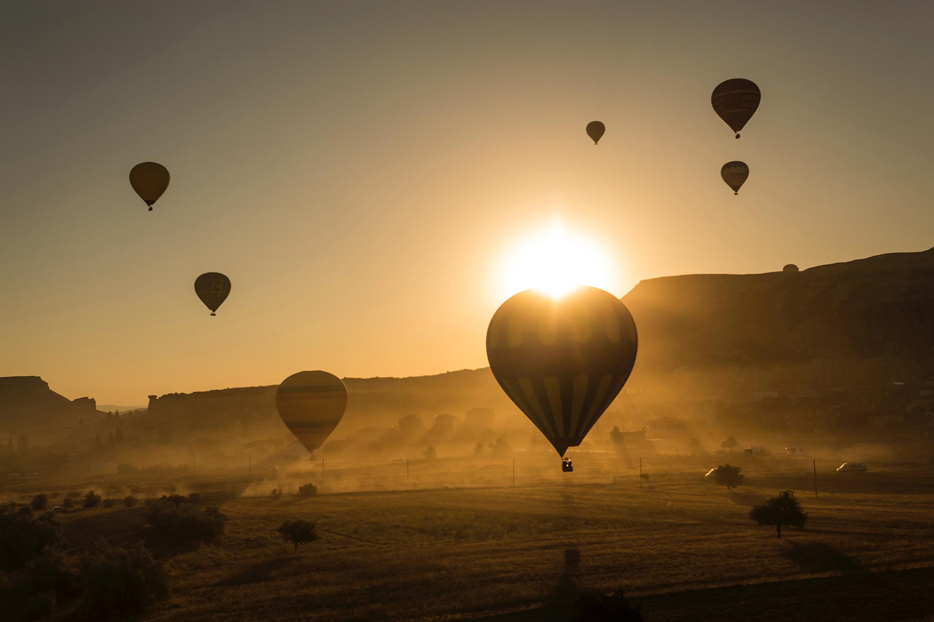 Air balloons floating in the sunset